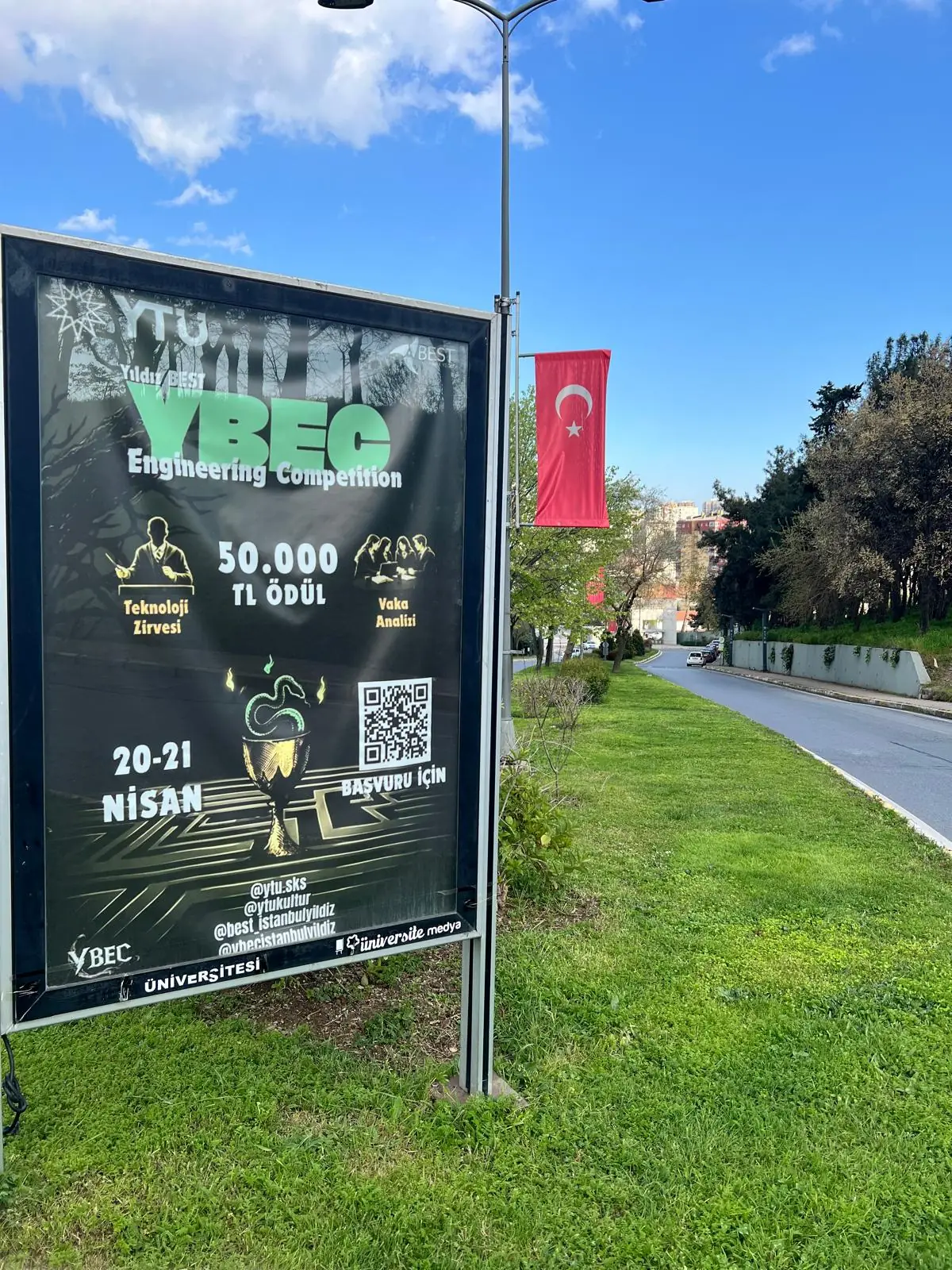 CLP poster panel beside a campus road