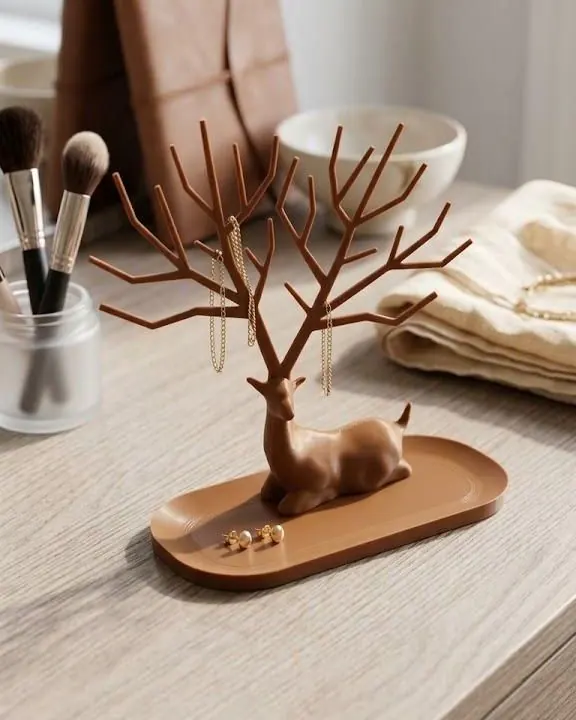 Deer-shaped jewellery tree on a wooden tray